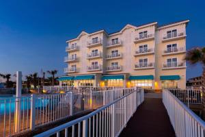a building on a boardwalk in front of a building at SpringHill Suites by Marriott New Smyrna Beach in New Smyrna Beach
