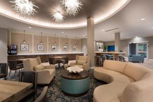 a lobby with couches and chairs and a table at SpringHill Suites by Marriott New Smyrna Beach in New Smyrna Beach