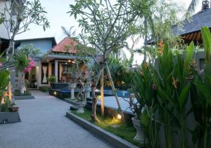 a courtyard of a house with trees and plants at Meilds Property Kuta in Kuta