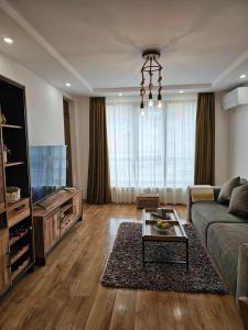 a living room with a couch and a television at Toni's hidden gem in Kazanlŭk