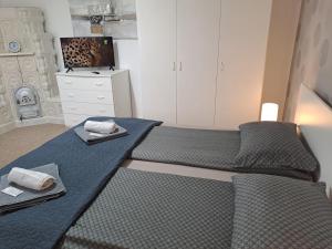 a bedroom with a bed and a tv in it at 7 Levél Panzió, Ultra Central, Self Check-in, Self-Catering in Miercurea-Ciuc