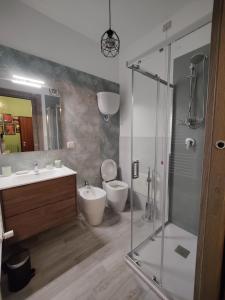 a bathroom with a shower and a toilet and a sink at Il Vicoletto Holiday Rooms in Spoleto