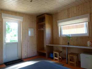 a kitchen with a counter and a window and a door at Mereoja Camping in Kõrkküla