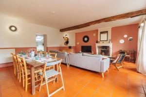 a living room with a table and a couch at LE GRAND FRANC gite cosy proche tous commerces in Tonnay-Charente
