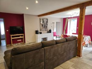 a living room with a couch and a television at Pont de la Chaux in Chaux-des-Crotenay