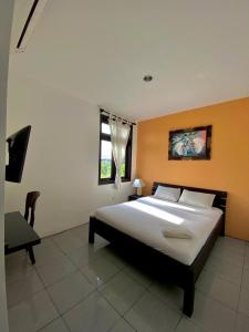 a bedroom with a large bed and a window at Meilds Property Kuta in Kuta