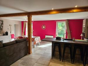 a living room with a table and a couch at Pont de la Chaux in Chaux-des-Crotenay