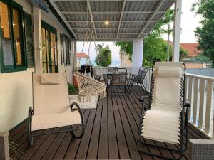 a porch with two chairs and a table on it at Privlaka Mobilhouses in Privlaka +24 photos