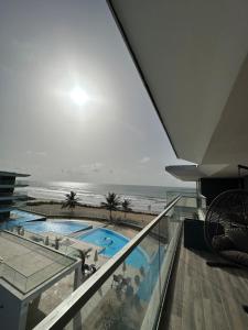 a view of the ocean from a building with a swimming pool at Far Out Apartments - Kololi Sands in Sere Kunda