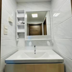 a bathroom with a sink and a mirror at Seaview 2B2R 6pax Forest City C5-2404 in Gelang Patah