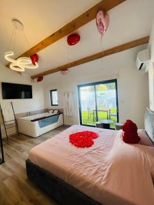 a bedroom with a large bed with red roses on it at Magnifique loveroom in Marseille