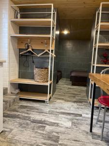 a room with wooden shelves and a floor with tiles at Nazar Stodolya in Kamianets-Podilskyi