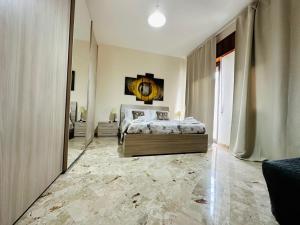 a bedroom with a bed and a mirror at B&B - Piazza Grande in Gela