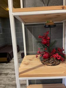 a table with a christmas tree and fruit on it at Nazar Stodolya in Kamianets-Podilskyi