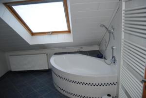 a bath tub in a bathroom with a window at Ferienwohnung Arnold in Vöhl