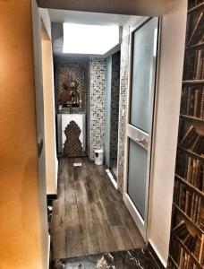 a hallway with a room with a book shelf at Dar Youssef Medina Sousse in Sousse