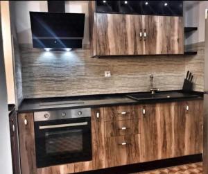 a kitchen with wooden cabinets and a sink and a stove at Dar Youssef Medina Sousse in Sousse +3 photos