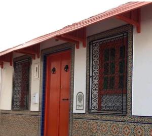 a building with two red doors and a red at Dar Youssef Medina Sousse in Sousse