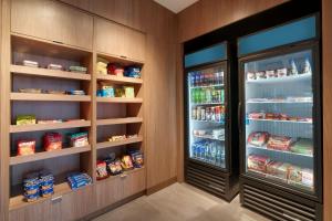 a walk in pantry with an open refrigerator at Fairfield by Marriott Inn & Suites Salt Lake City Cottonwood in Holladay