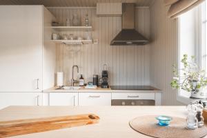 a kitchen with a wooden table and a sink at White House - Panoramic View in Reine