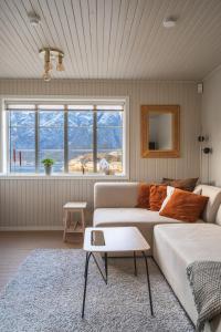 a living room with a couch and a table at Little White House in Reine