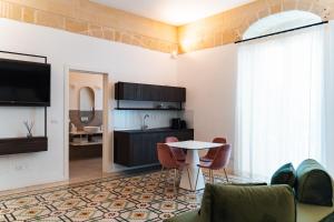 a living room with a table and chairs at Le Vie Del Centro Luxury Room in Matera