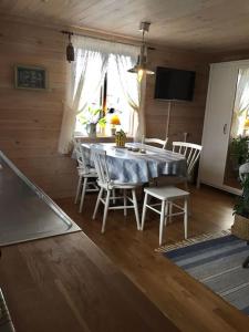 a dining room with a table and chairs at Mitt i vackraste Bohuslän in Lysekil +78 photos