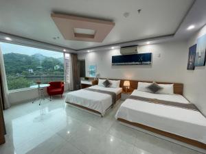 a hotel room with two beds and a window at Seoul Motel Seaview in Cat Ba