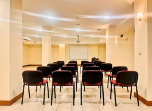 a conference room with chairs and a whiteboard at Hotel O Guerreiro in Ponte da Barca