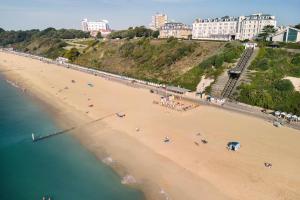 an aerial view of a beach with people on it at Bournemouth Highcliff Marriott Hotel in Bournemouth