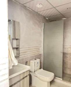 a bathroom with a toilet and a sink and a tub at Karam Wadi Rum camp in Wadi Rum