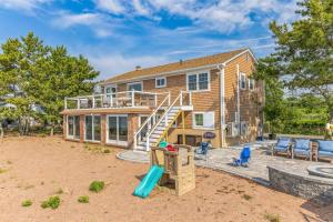a house with a slide and a playground at Sunrise Cove - Oceanfront Bliss Luxury Beach Retreat in East Haven