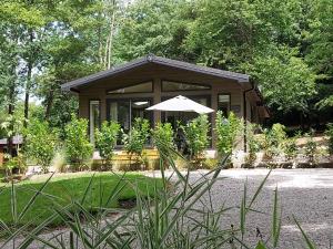 a small cabin with an umbrella in a garden at Chycara House in Truro