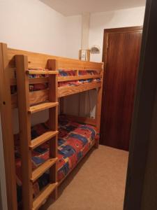 a bedroom with two bunk beds and a bed at Chamrousse - Résidence Le Vernon in Chamrousse