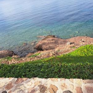 a view of the ocean from a rock ledge at Ithaca in Perdika