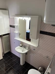a bathroom with a sink and a mirror at Machi's Apartment in Markopoulo +17 photos