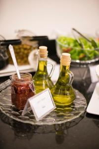 two bottles of oil on a glass plate on a table at Dweik Hotel 2 in Aqaba