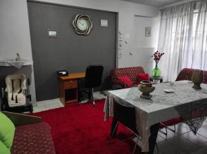 a living room with a table and chairs at NASOS APARTMENT METEORA in Kalabaka