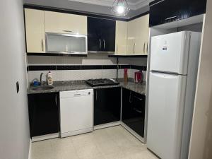 a kitchen with white appliances and a white refrigerator at Tas Homes Antalya in Antalya