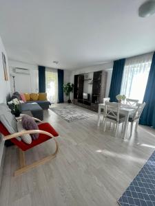 a living room with a couch and a table at Fly Airport Residences & Therme-SELF CHECK-IN in Otopeni