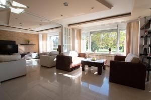 a large living room with couches and a tv at Sweet House Parlament Lux in Belgrade