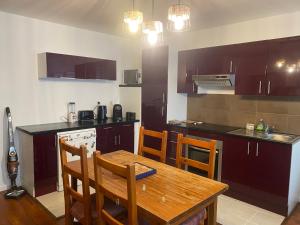 a kitchen with a wooden table and a table and chairs at Charmant T2 in Rives