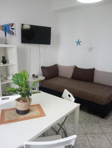 a living room with a couch and a table at Matteo's House Taormina in Taormina