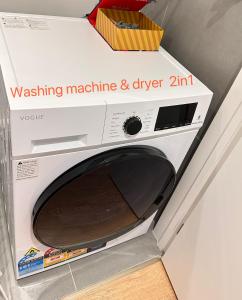 a microwave oven with a box on top of it at Brandnew modern apartment in Auckland