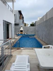 a swimming pool on the side of a building at Luxury Villa at Ain-Diab in Casablanca