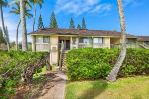 a house with palm trees in front of it at Ilima West Kuilima Estates 18 At Turtle Bay in Kahuku