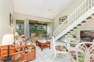 a living room with a couch and a staircase at Ilima West Kuilima Estates 18 At Turtle Bay in Kahuku