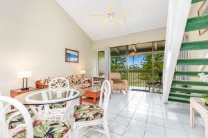 a living room with a table and chairs at Ilima West Kuilima Estates 18 At Turtle Bay in Kahuku
