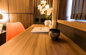 un tavolo in legno con un portatile e un vaso sopra di Superior 1 Bed Studio -4D- near Royal Infirmary & DMU a Leicester