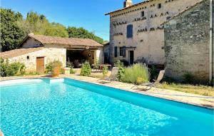 a swimming pool in front of a building at Stunning Home In Prailles With Outdoor Swimming Pool in Prailles